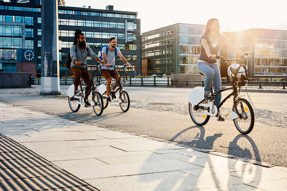 three-people-cycling-in-city